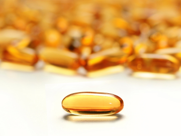 Una píldora amarilla semi-translúcida, representando los productos farmacéuticos de síntesis. Esta píldora simboliza la precisión y calidad de los procesos de fabricación y control realizados por Eurofins BioPharma Product Testing, una empresa líder en el análisis y prueba de productos farmacéuticos, comprometida con la excelencia en la industria.